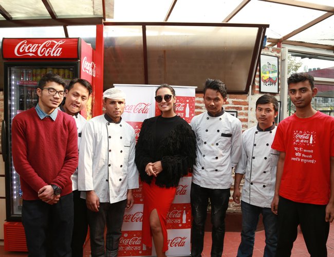 Priyanka Karki shares a moment with outlet staff during Coca-Cola Momotsav outlet visit.jpg